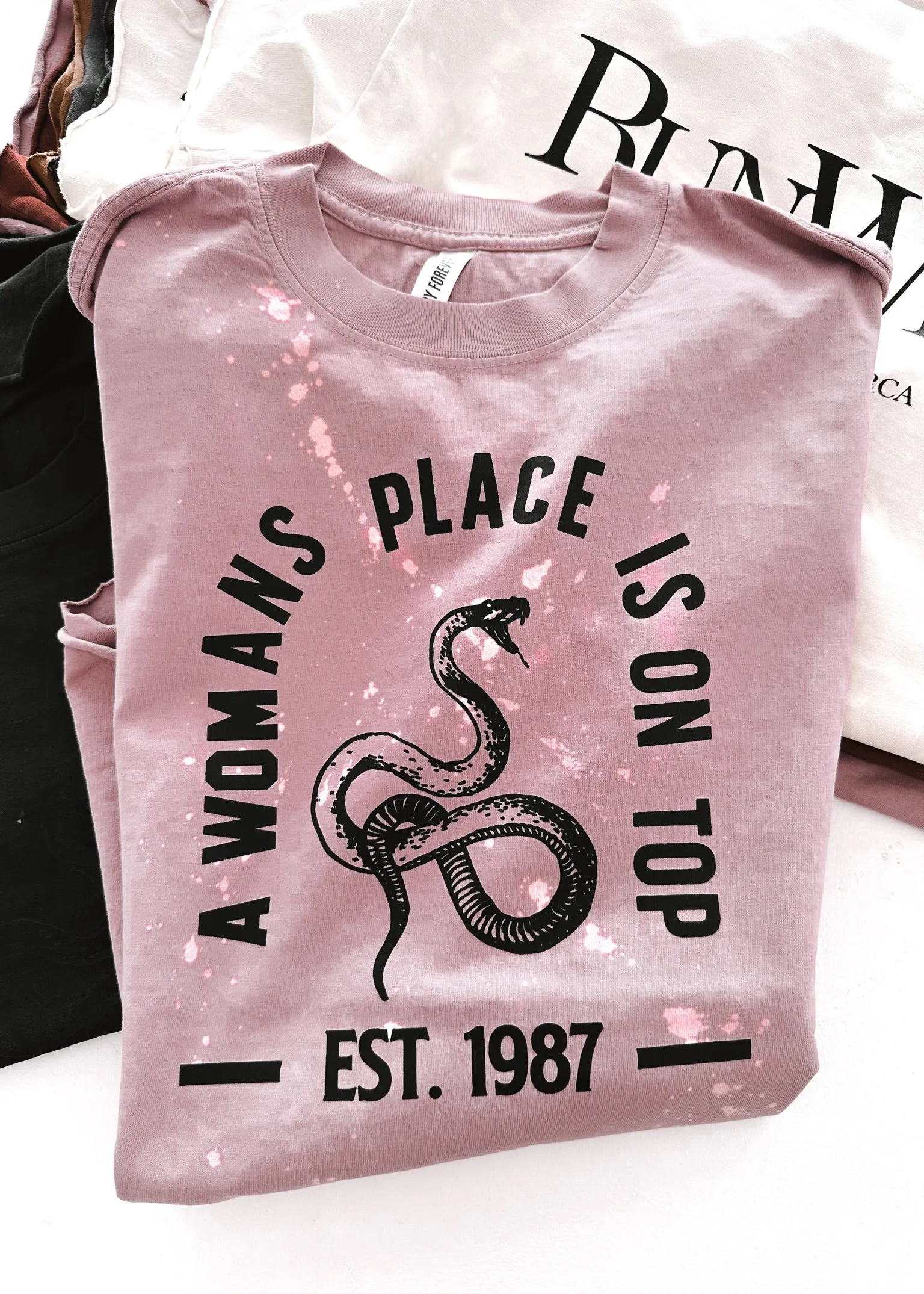 A WOMAN'S PLACE IS ON TOP BLEACHED OUT SIDE SLIT TEE